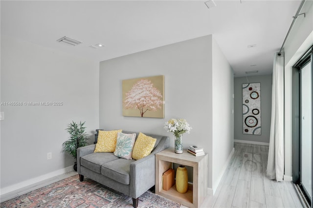 sitting room featuring light hardwood / wood-style flooring