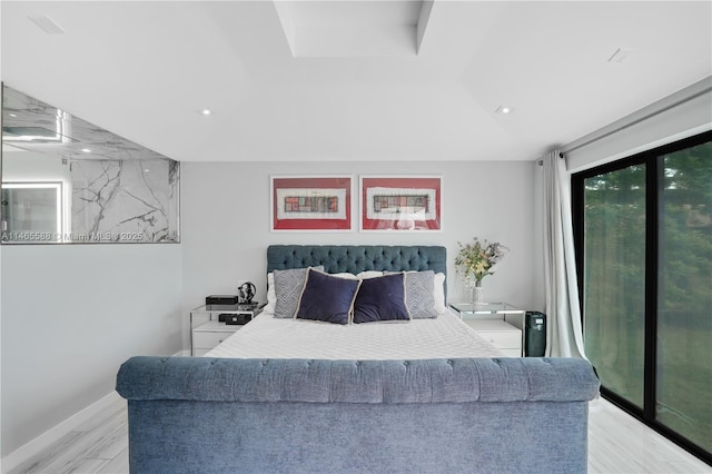 bedroom featuring access to exterior and light wood-type flooring