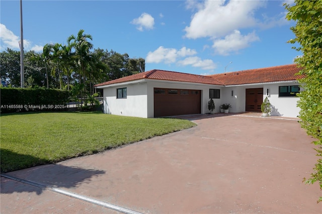 view of front of home featuring a garage and a front yard