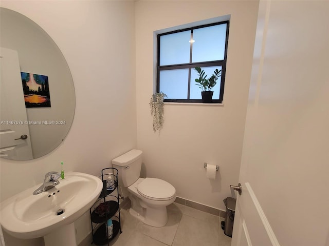 bathroom with sink, tile patterned flooring, and toilet