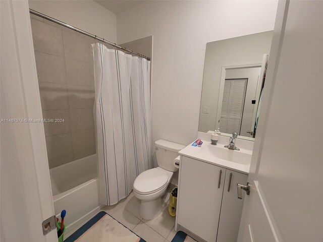 full bathroom featuring shower / tub combo, tile patterned flooring, vanity, and toilet