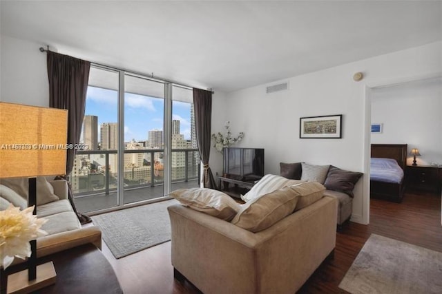 living room featuring dark hardwood / wood-style floors and a wall of windows