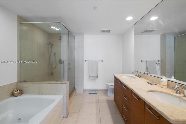 full bathroom with double sink, independent shower and bath, tile floors, toilet, and oversized vanity