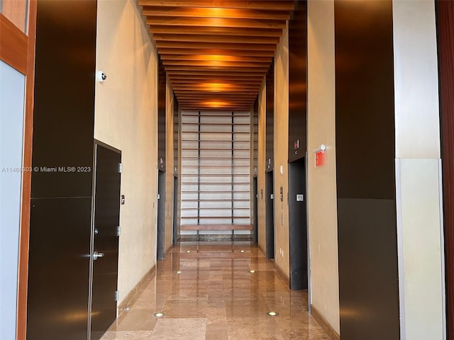 hallway with dark tile floors