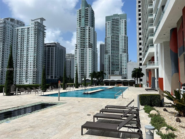 view of swimming pool with a patio area