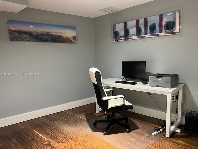 home office with dark hardwood / wood-style floors