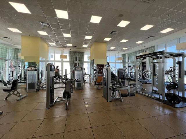 gym with a paneled ceiling