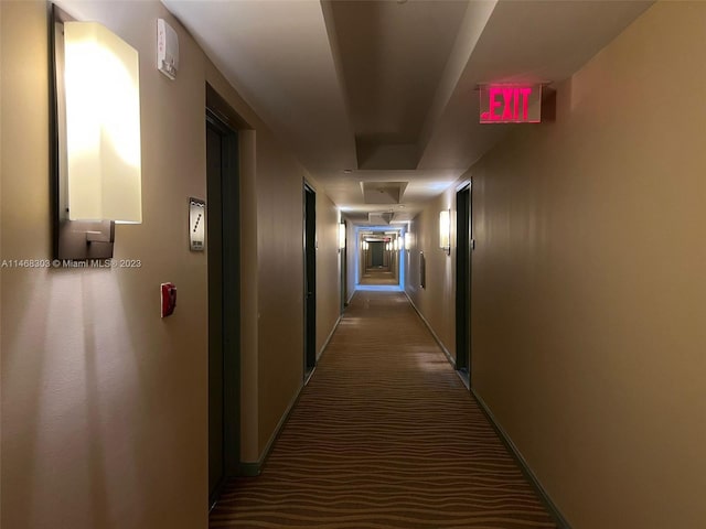 corridor with dark colored carpet