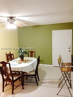 dining room featuring light tile flooring and ceiling fan