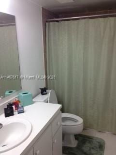 bathroom featuring oversized vanity and toilet