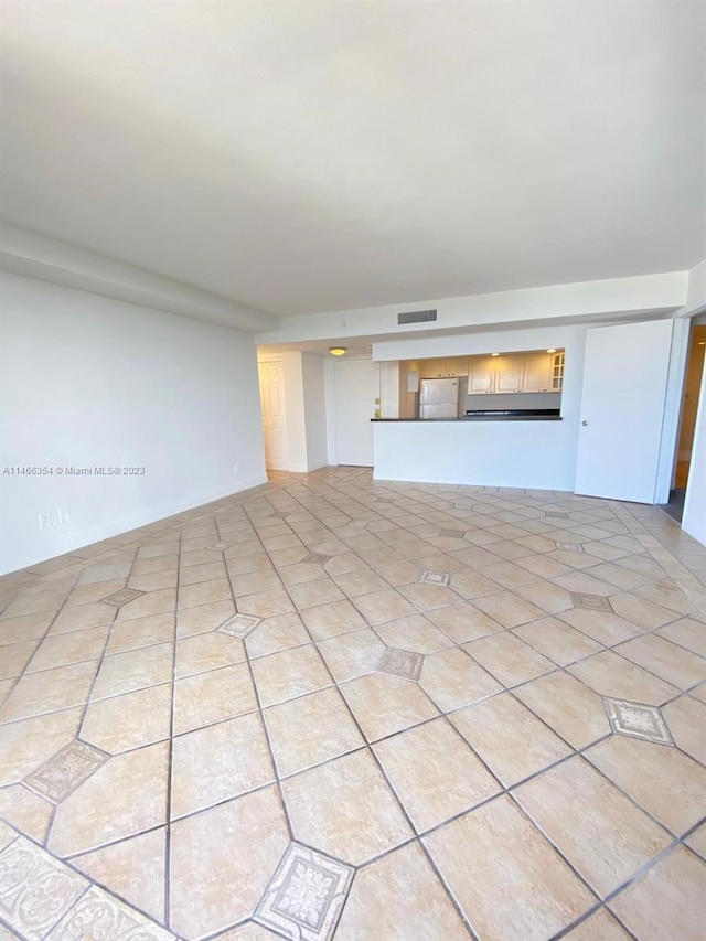 unfurnished living room with light tile floors