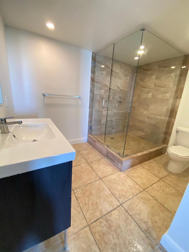 bathroom featuring vanity, tile flooring, a shower with door, and toilet