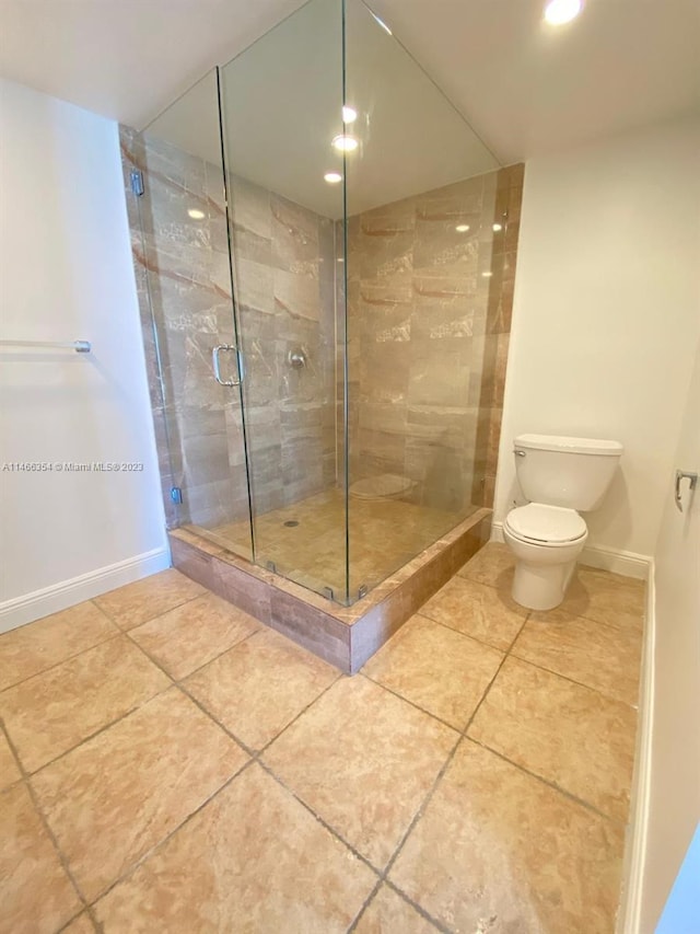 bathroom featuring walk in shower, tile floors, and toilet