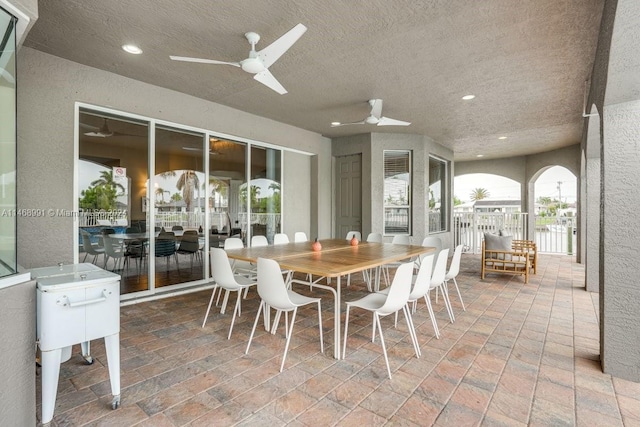 dining area with ceiling fan and a textured ceiling