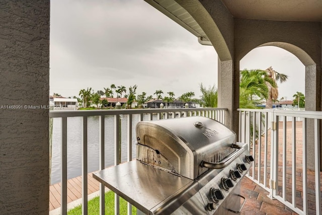 balcony featuring a water view and area for grilling