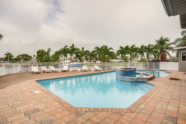 view of pool featuring a patio area and a hot tub