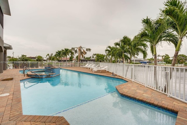 view of pool featuring an in ground hot tub and a patio area