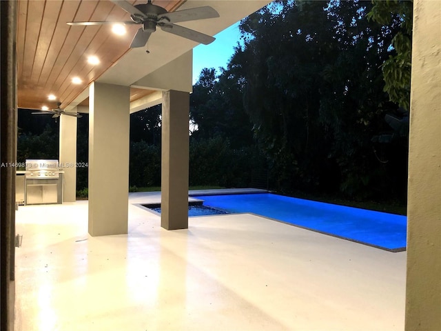 view of pool featuring a patio, an outdoor kitchen, and grilling area