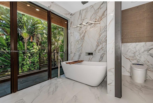 bathroom featuring tile walls and a tub to relax in