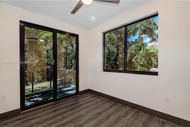 unfurnished room featuring ceiling fan and dark hardwood / wood-style floors