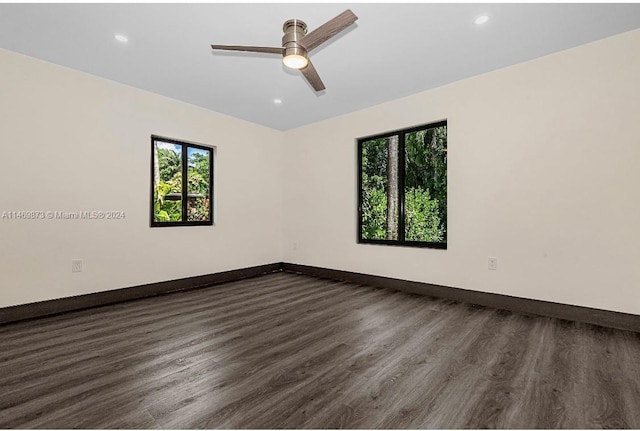 unfurnished room with dark hardwood / wood-style floors and ceiling fan