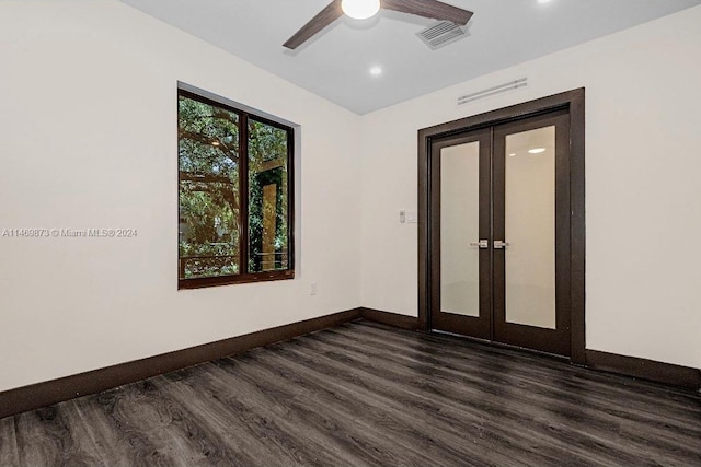 spare room with dark hardwood / wood-style floors, ceiling fan, and french doors