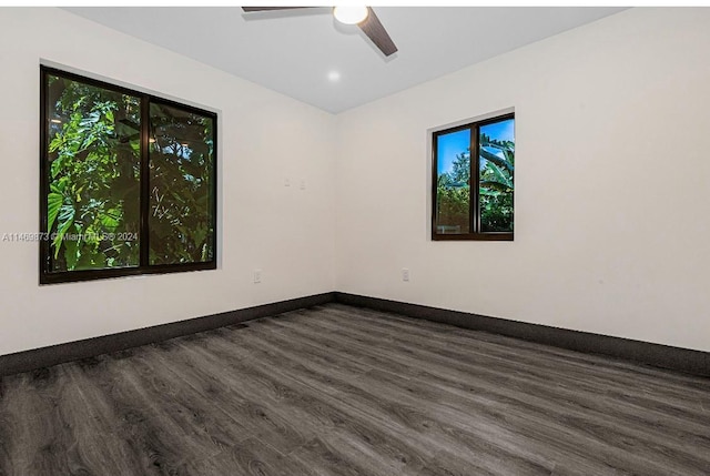 empty room featuring dark wood-type flooring and ceiling fan