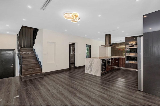 unfurnished living room featuring wine cooler and dark wood-type flooring