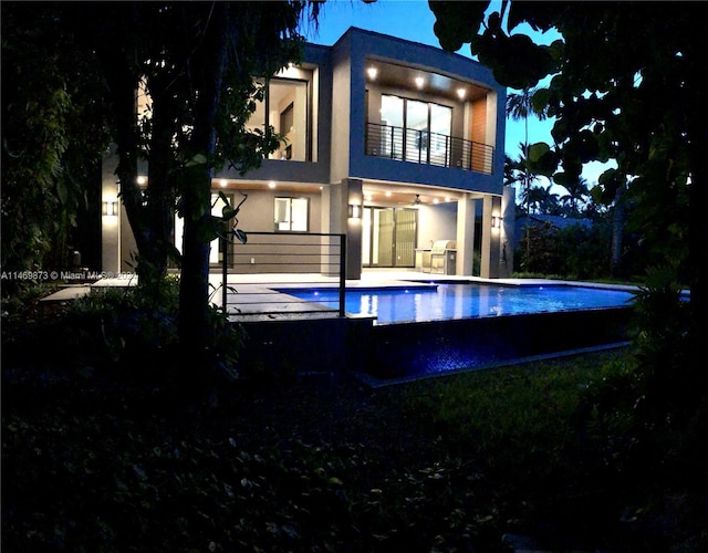 back of house featuring a patio and a balcony