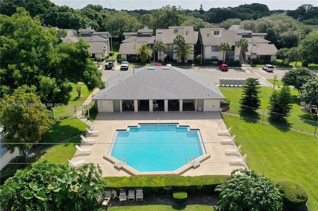 view of pool with a lawn and a patio area