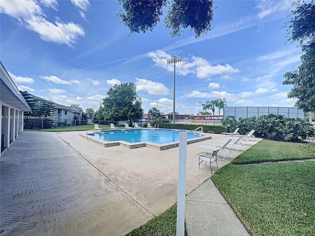 view of pool featuring a yard and a patio area