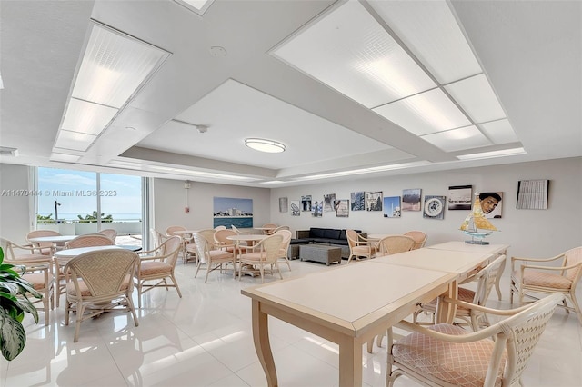 dining room with floor to ceiling windows and light tile floors