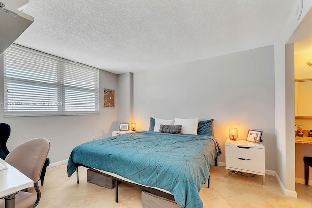 tiled bedroom with a textured ceiling