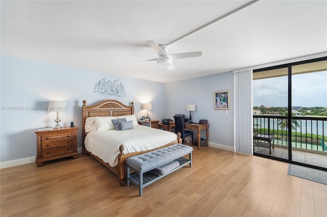 bedroom featuring ceiling fan, light hardwood / wood-style floors, access to exterior, and a water view