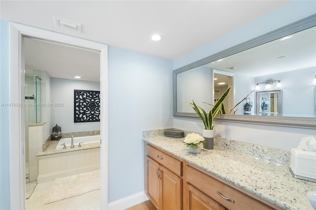 bathroom with separate shower and tub and vanity