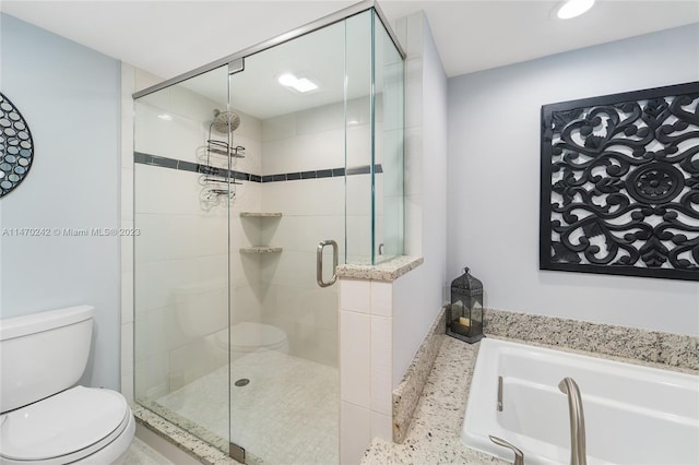 bathroom featuring separate shower and tub and toilet