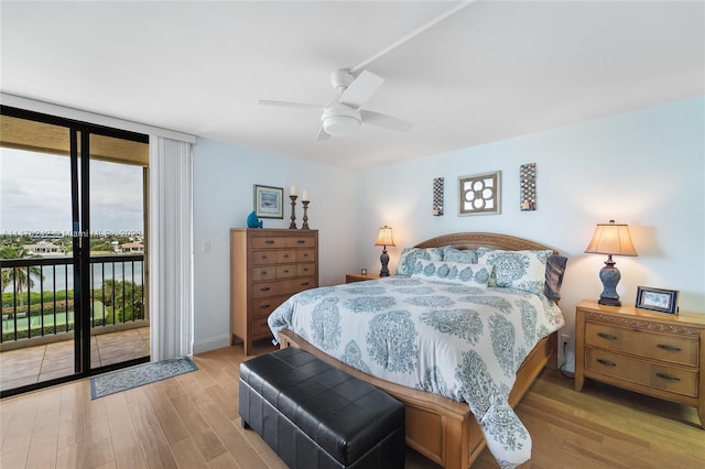 bedroom featuring ceiling fan, a wall of windows, light wood-type flooring, and access to outside