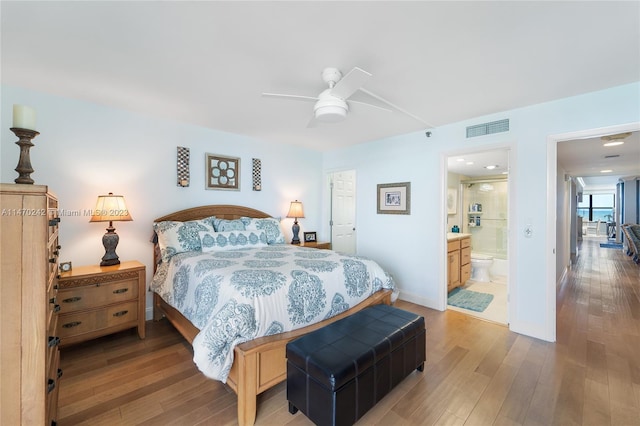 bedroom featuring connected bathroom, ceiling fan, and light wood-type flooring