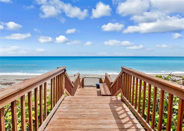 view of home's community with a beach view and a water view