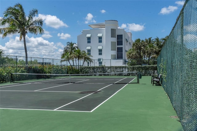 view of tennis court with basketball hoop