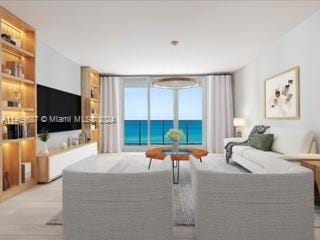 living room with a water view and light hardwood / wood-style flooring