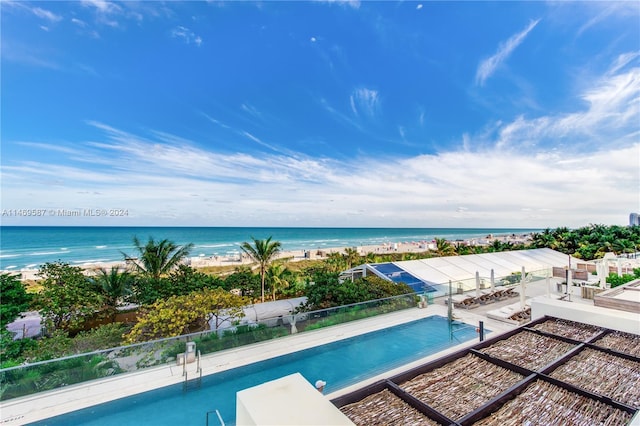 view of pool with a water view