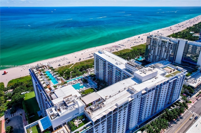 drone / aerial view featuring a beach view and a water view