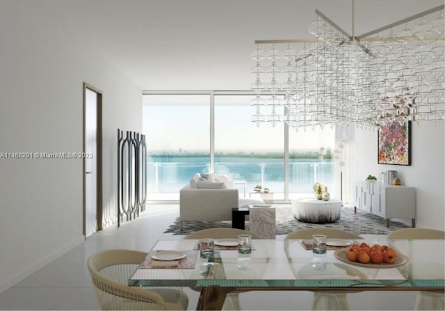 tiled dining space featuring plenty of natural light, an inviting chandelier, and a water view