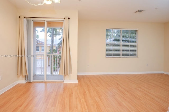 unfurnished room with a wealth of natural light and light wood-type flooring