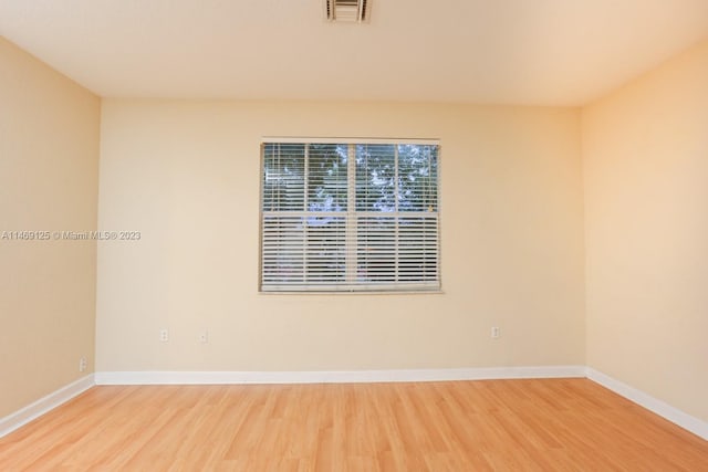 spare room featuring hardwood / wood-style floors