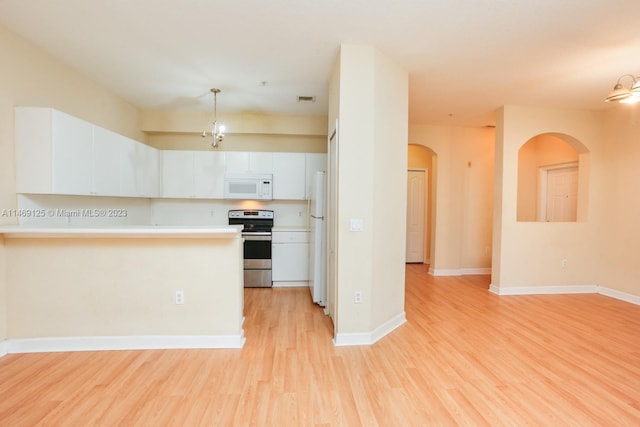 kitchen featuring white appliances, light hardwood / wood-style floors, white cabinetry, and decorative light fixtures