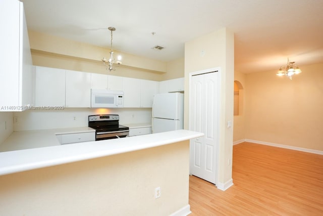 kitchen with hanging light fixtures, white cabinets, light hardwood / wood-style floors, an inviting chandelier, and white appliances