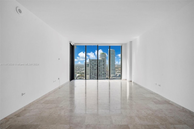 tiled spare room with expansive windows