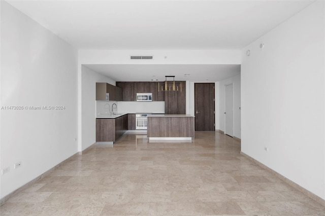 interior space with light tile floors and sink